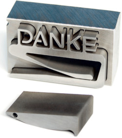 metal component with inscription "danke"