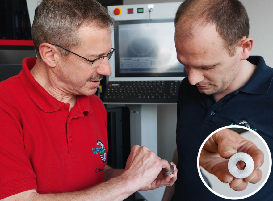 Training and Toolshop Manager Otto Hebding discusses the details of a gearwheel contour with wire-cutter Wilhelm Michelis.