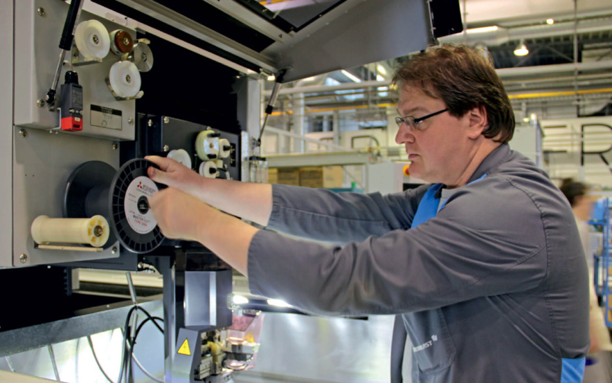 Harald König ­threading the new wire – no problem thanks to automatic wire threading.