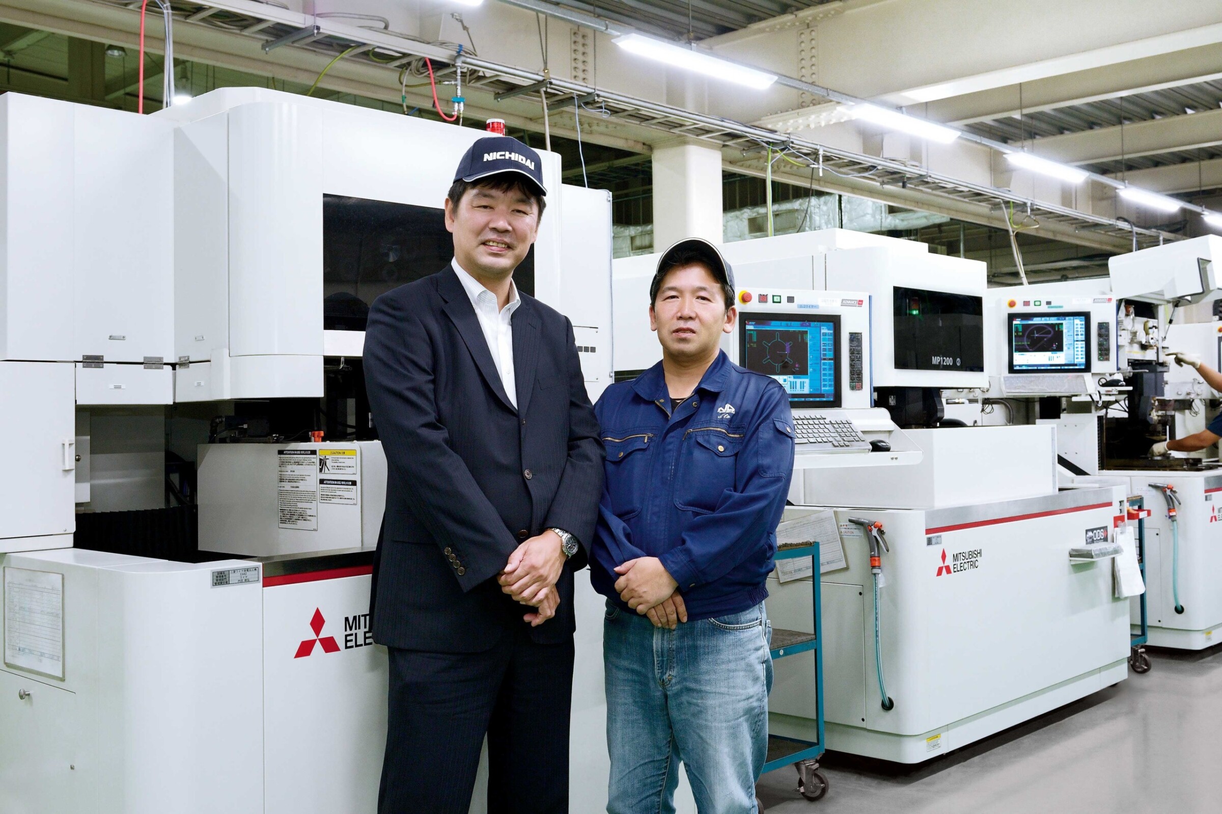 Production Manager Masato Ito (right) and Mitsubishi Electric’s West branch EDM section manager Satoshi Aoki (left).