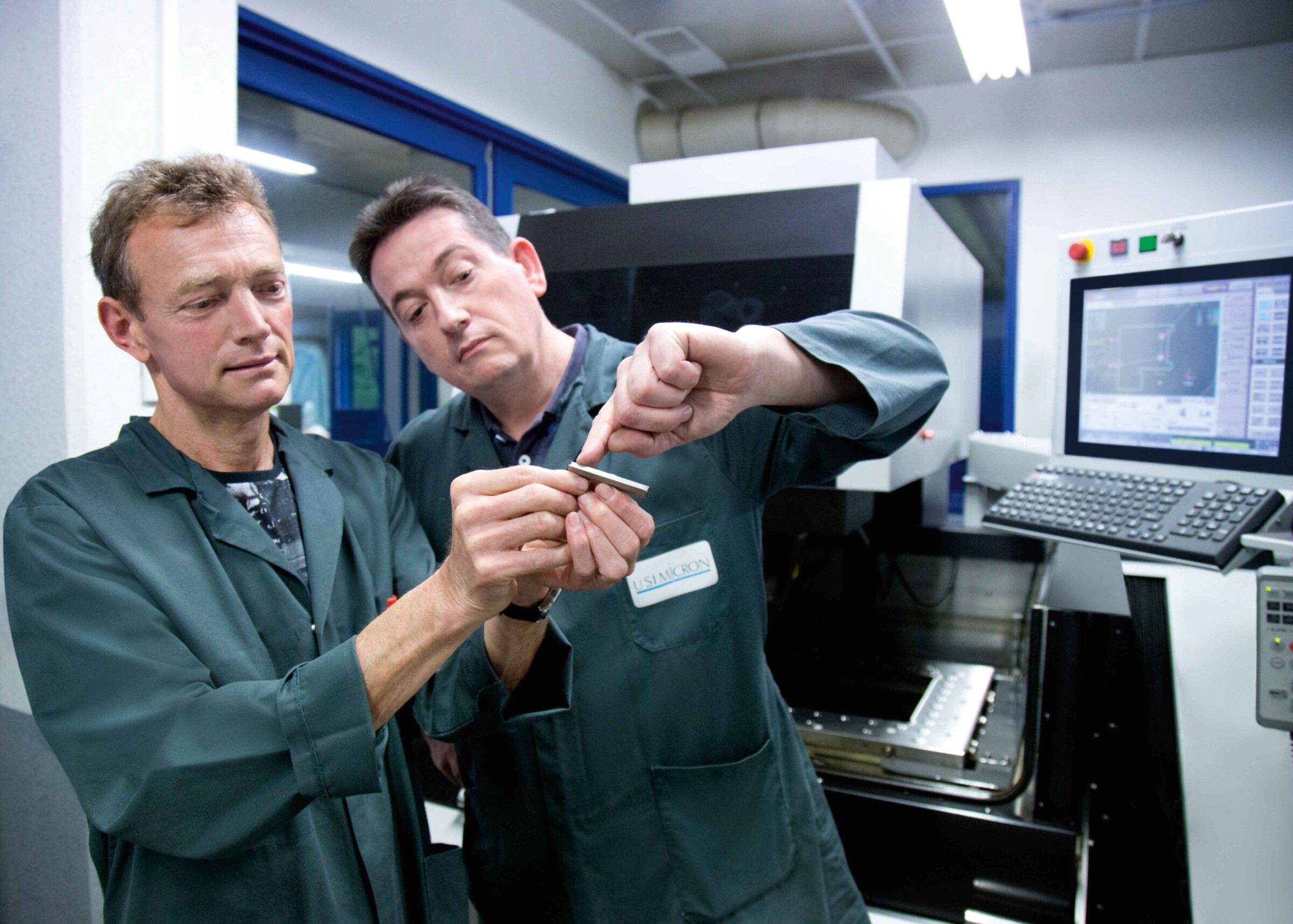 Alain Perrenoud, owner and Managing Director of USIMICRON in Besançon, and Sébastien Devernay, toolmaker and EDM and grinding specialist, checking the quality of the wire-cut components