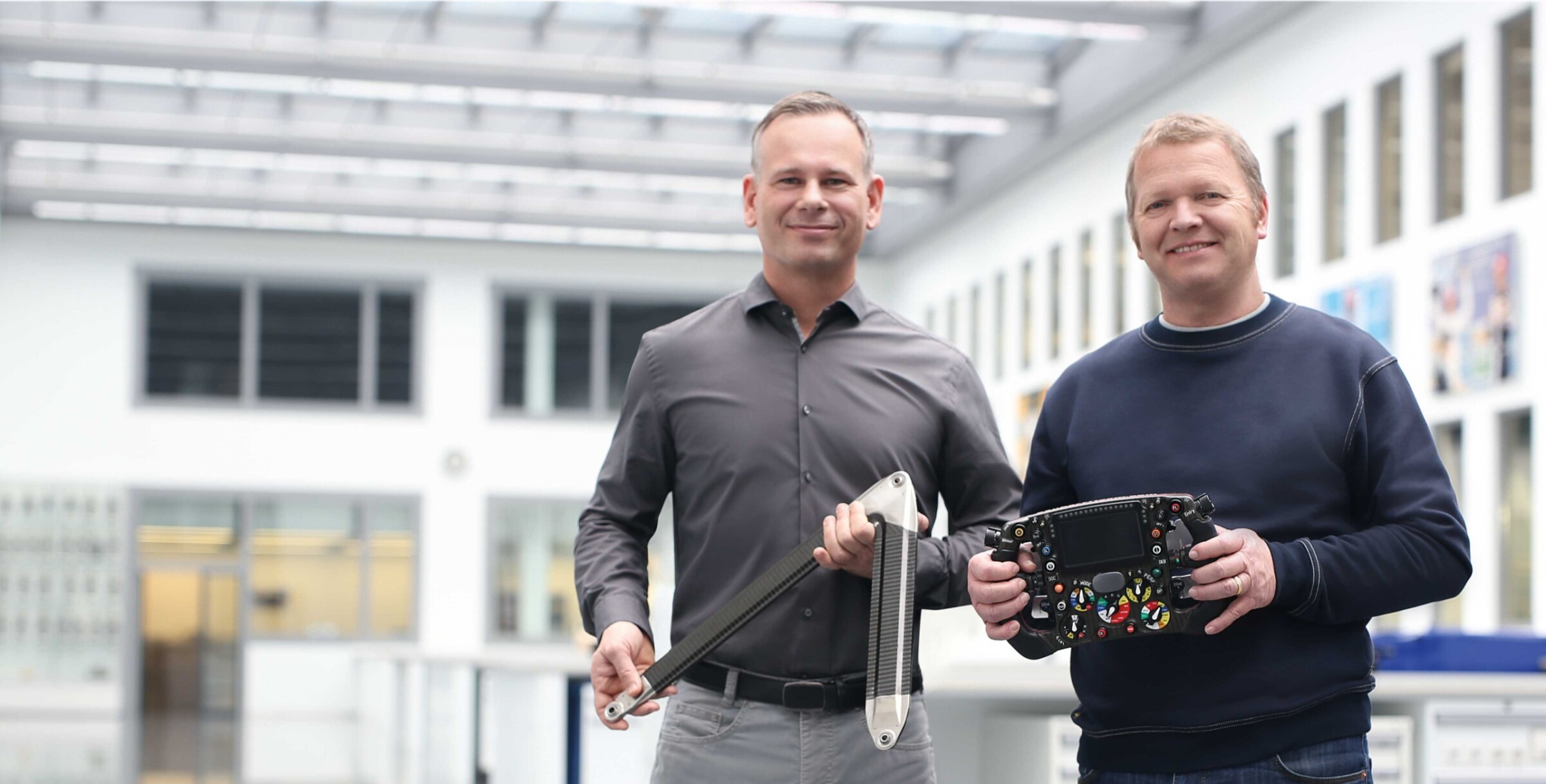 F. l. t. r.: Axel Kruse, Operations Director, and Ernst Keller, Production Manager, with EDM-machined elements of the Formula One vehicle.