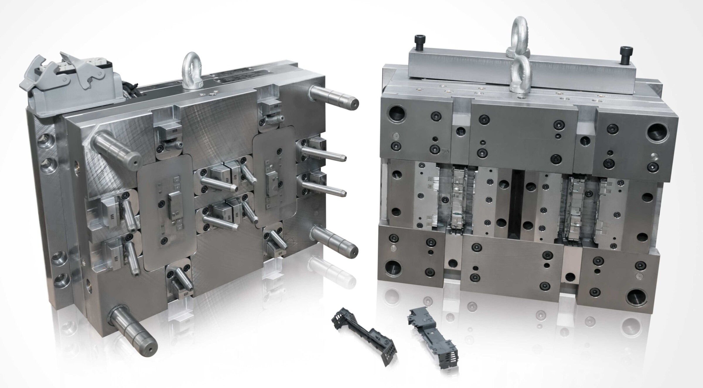 An injection mould for components of an industrial control system with two cavities and heated melt guidance system. The movable elements form a tight seal in their end positions.