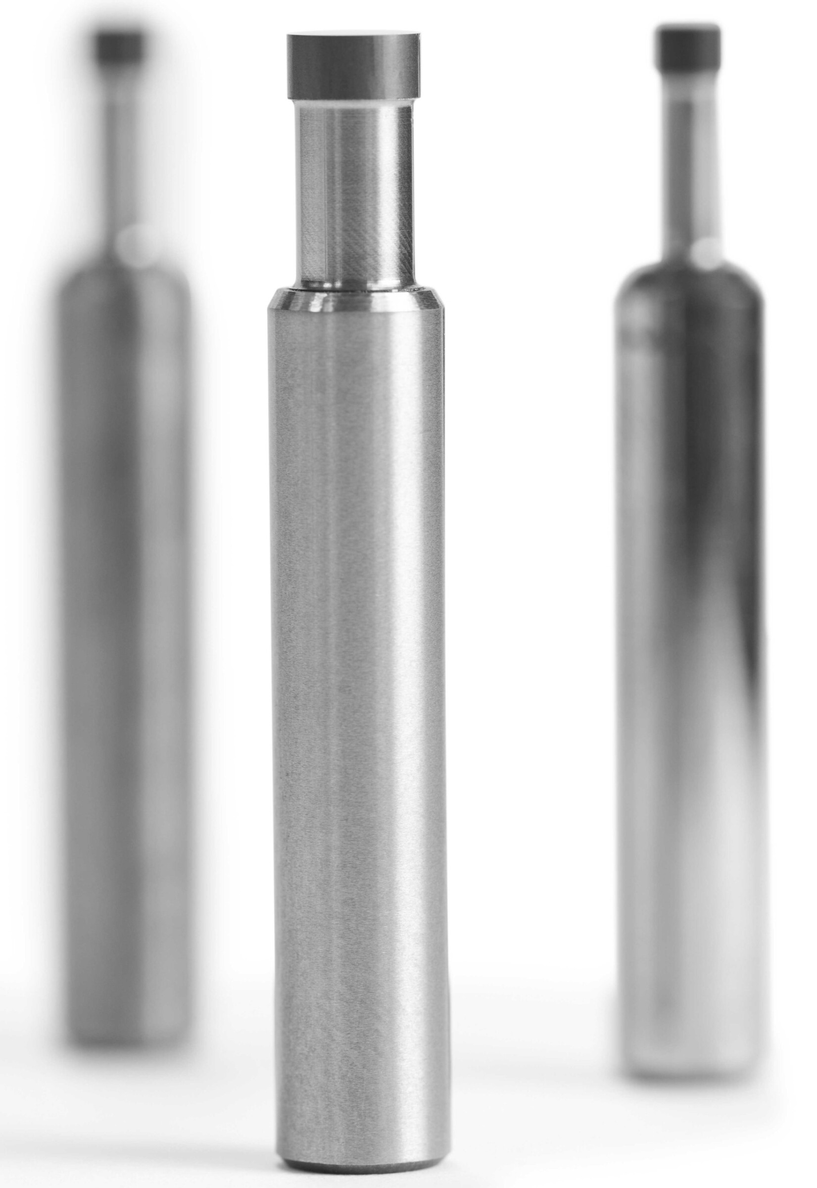 Round-ground carbide tool blanks with a sintered PCD diamond layer after being cut out of a round blank by wire erosin.