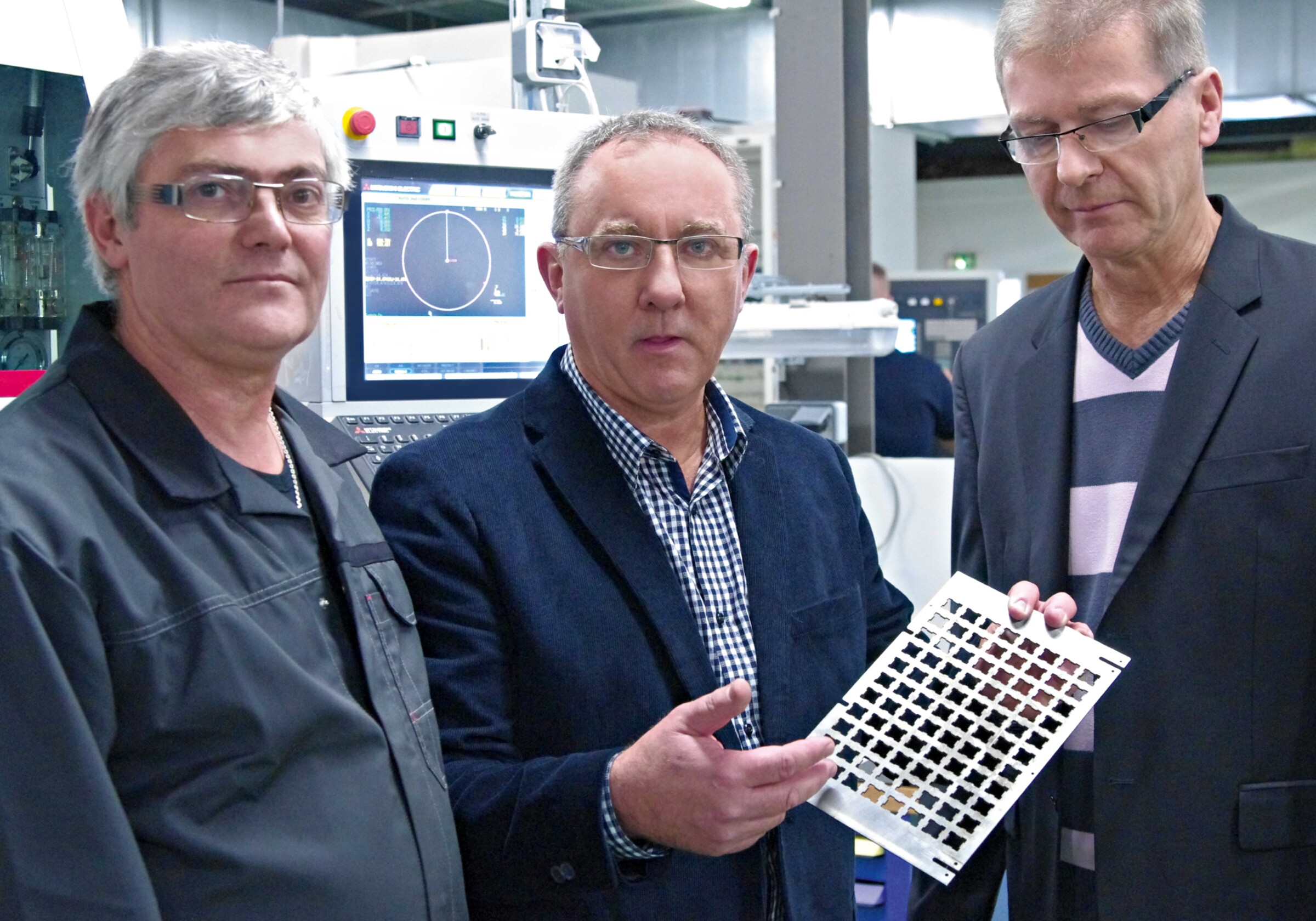 Jacques Meudec, wire EDM specialist, and Jean-Pierre Morin and Christian Mignon, who jointly manage AMEP (from the left), are delighted with the high-grade ­machining results of the MV1200S wire-cut EDM machine during the cutting of press samples.